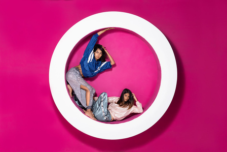 two leading models posing in large white wheel for tv show Indias next top model Mtv photography challenge by leading indian fashion photographer based in mumbai india