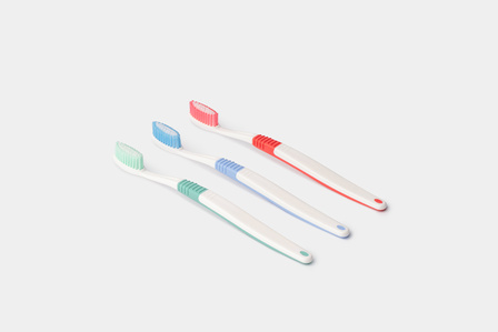 Professional photoshoot with colour variations of three tooth brushes in studio setting on plain white background for website design of emerging  brand by best luxury product photographer ashish gurbani based in Mumbai India.
