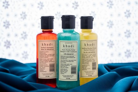 herbal shampoo cosmetic concept photoshoot with lace background on blue fabric by leading product photographer ashish gurbani based in mumbai india