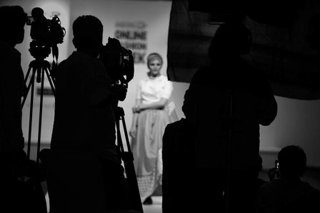 a black and white shot in a candid form of photographers taken photos of a model in a studio set up taken professionally by leading commercial photographer ashish gurbani based in pune india