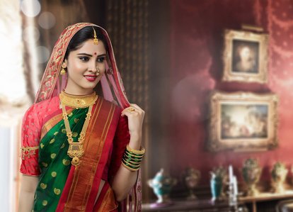 a mid length image of a model posing in a maharashtrian saree wearing gold jewellery for a jewellery product campaign photoshoot shot by best jewellery photographer based in pune and Mumbai india