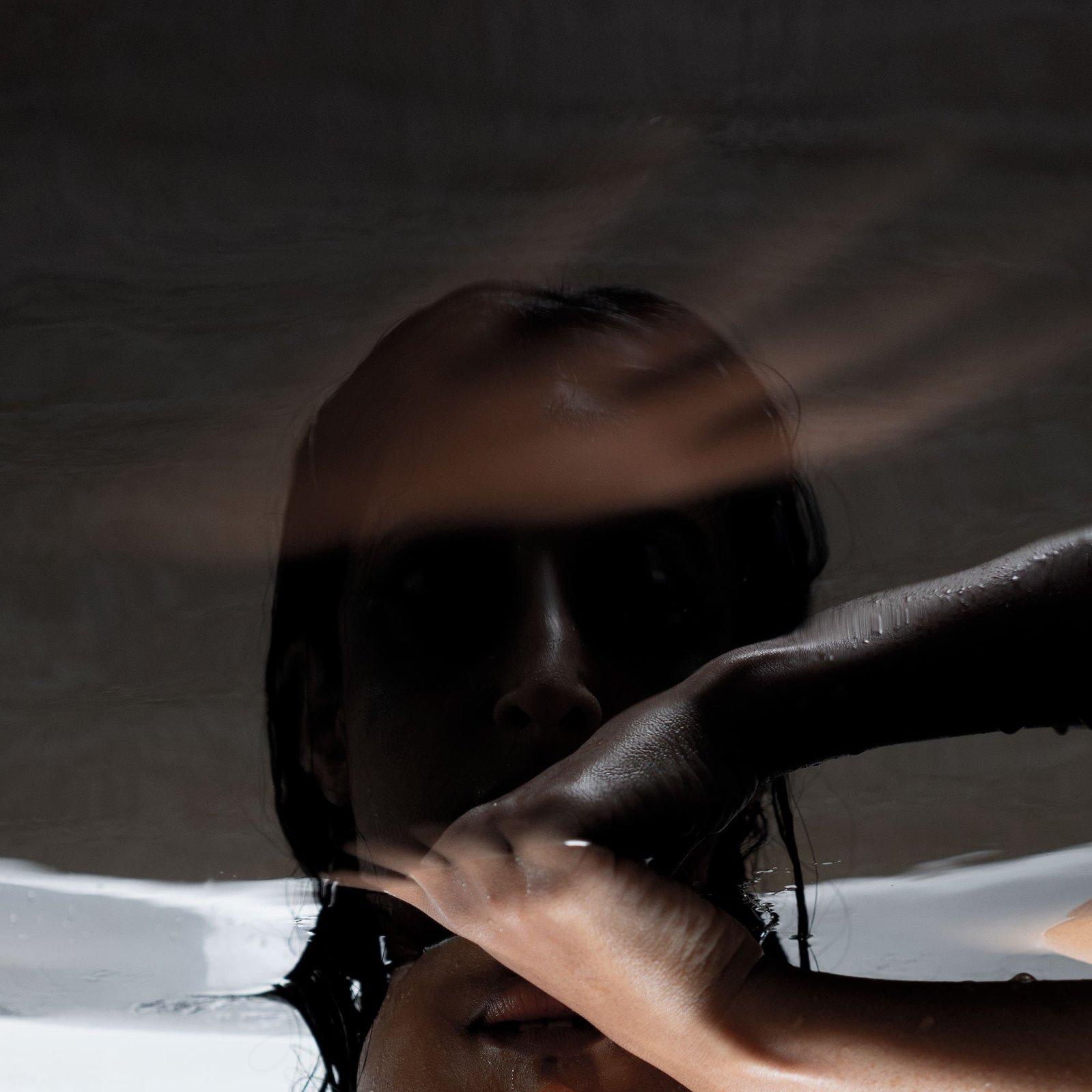 dark depressed girl reflection in black water concept photoshoot by best indian fashion photographer based in mumbai india