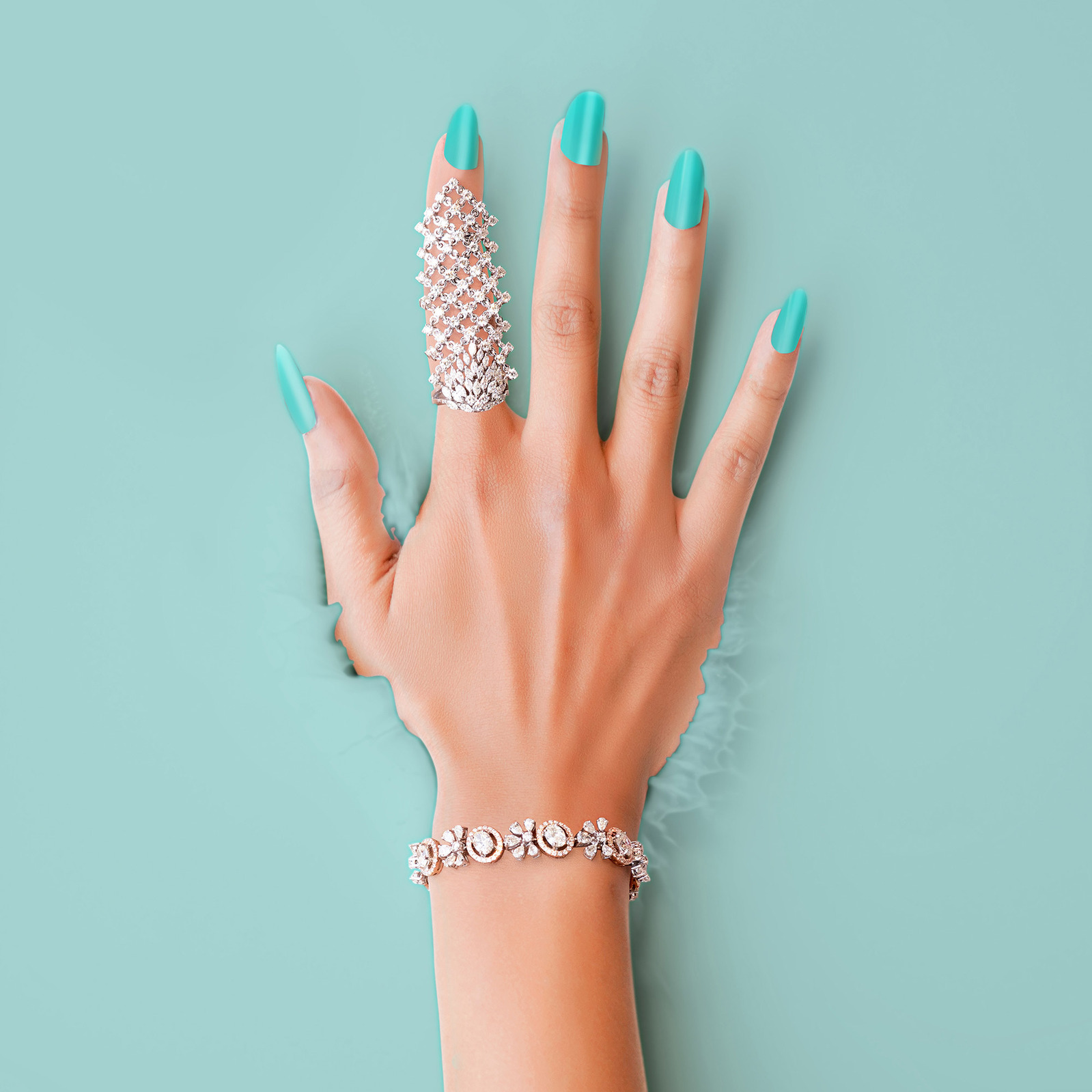 a professional photoshoot of a hand with diamond jewellery splashing in coloured liquid a concept photograph shot with top indian jewellery photographer ashish gurbani based in mumbai india