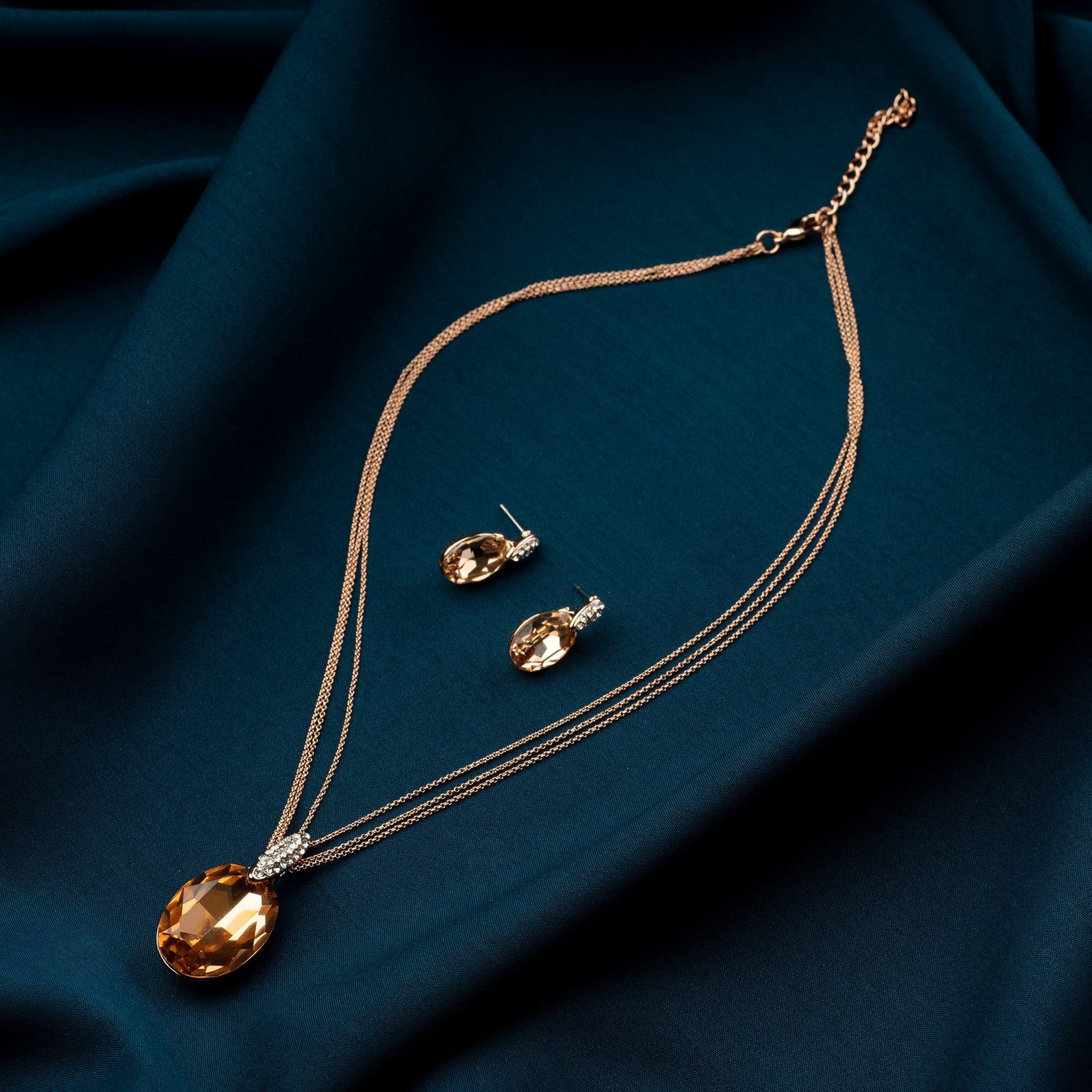 professional product photography of a rare stone necklace on blue wave cloth concept shoot in studio setting with best commercial photographer ashish gurbani based in mumbai india
