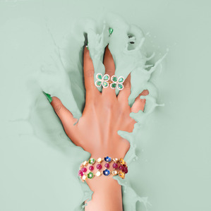 a professionally shot colour water splash concept photoshoot of a hand splashing in coloured liquid with jewellery on shot for leading jewellery brand by top jewellery photographer ashish gurbani based in mumbai india