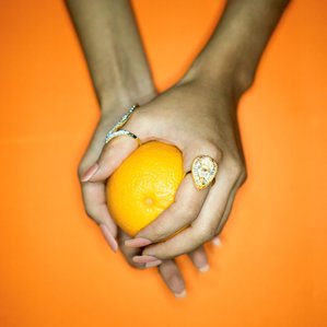 hand holding an orange concept photography by best conceptual fashion photographer based in mumbai india