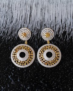 a pair of beautiful diamond earrings placed on an ice block photographer by merging luxury product photographer based in pune