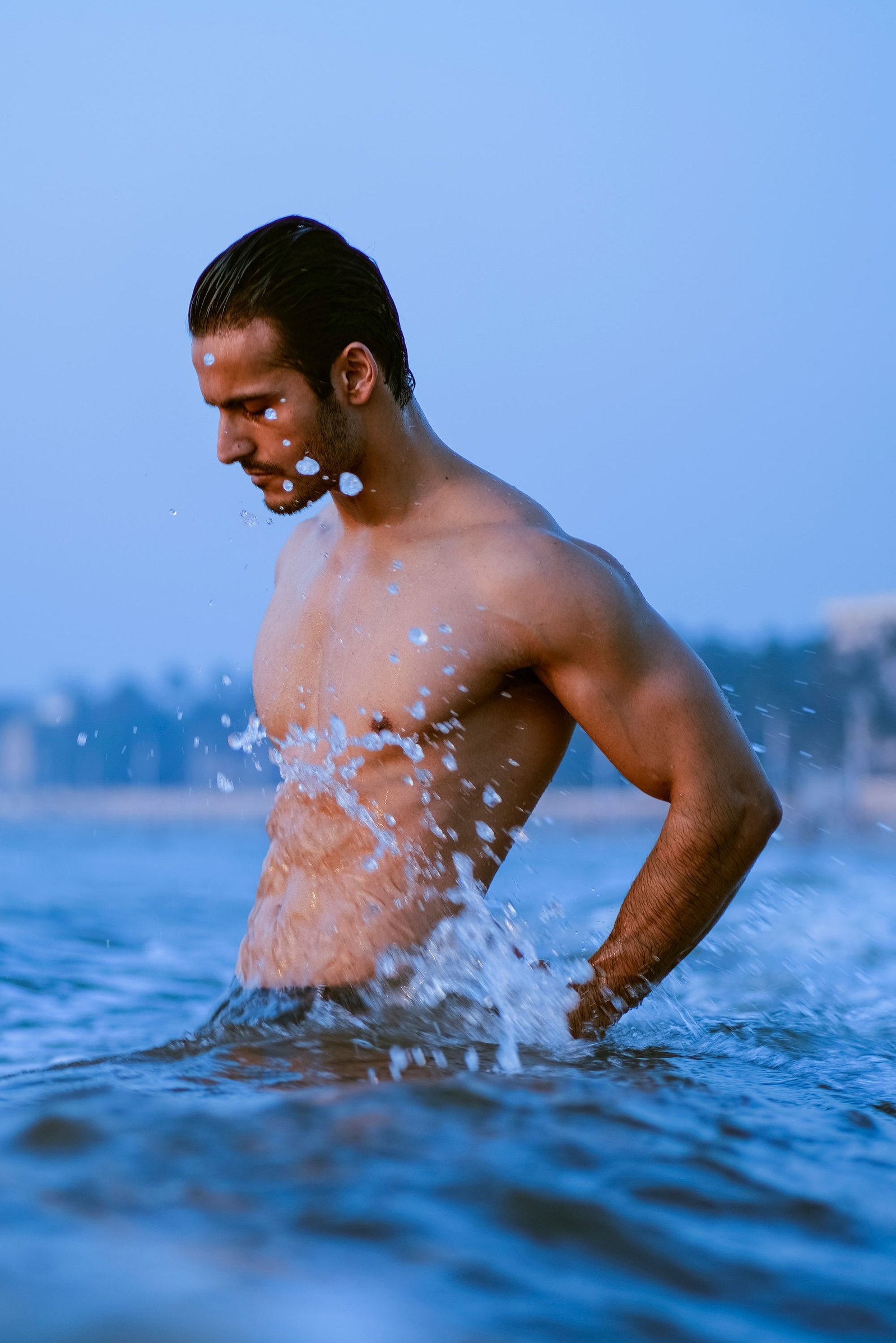 photoshoot of waves splashing against the body of fashion model angel singh professionally shot by the best creative photographer ashish gurbani based in mumbai india