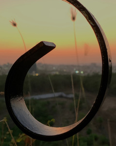 photograph of sunset through the balcony grill made me see the inverse of the sky colours on the metal shot by top advertising photographer ashish gurbani based in Mumbai india