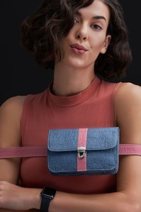a duel colour bag strapped onto a model hands posing for the camera being shot by one of the top luxury photographer based in Pune India