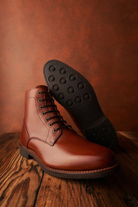 maroon red leather shoes photographed on a wooden table top by best product photographer specialising in footwear mumbai
