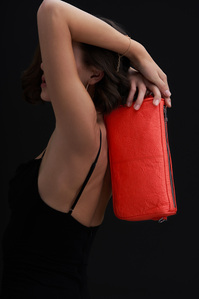 a blood red bag being held by a model on her back in an abstract manner photographed by best campaign photographer based in mumbai inia