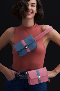 A beautiful female model standing wearing to dual-tone bags for a fashion brand campaign shot by best advertising photographer based in Pune India