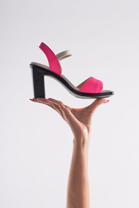 lifestyle photoshoot of a hand holding pink heels in mumbai

