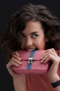 A gorgeous model is biting into a plant-based leather bag manufactured by brand A Big Indian Story shot by the top Fashion Photographer based in Mumbai Indi
