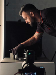 Behind the scene of Product Photographer experimenting in the studio with perfume bottles.