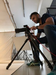 a low-angle view of a commercial photographer setting up a hasselblad x2d for ad photography in India
