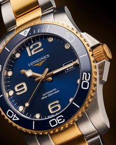 a macro shot of a longines gold luxury watch on a dark background photoshoot by top luxury watch photographer based in pune