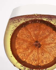 an orange immersed in a wine glass bubbling photographed by leading commercial photography studio in Mumbai