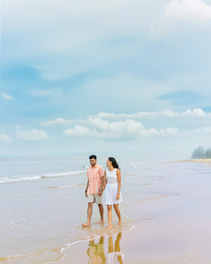 a couple walks on a beautiful sunset beach during dusk photographed by best hotel photographer based in pune india
