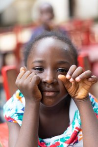 Close up portrait shot of a young girl posing with her hands shot by Ashish Gurbani best advertising photographer based in Mumbai India.