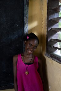 Boy smiling and enjoying in the corner of a room shot by ashish gurbani best photographer based in mumbai india.