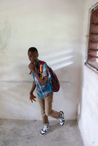 Boy smiling and posing in the corner of a room shot by ashish gurbani top photographer based in mumbai india.