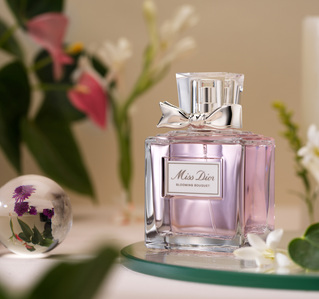 a blossom pink perfume bottle by miss dior placed on a flowery concept set photographed with studio lighting for branding campaign photo and video artist