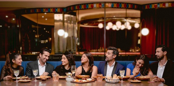a group of friends enjoy a luxury dinner experience with leading hotel photographer in Mumbai india