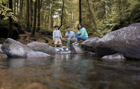 a young family captured by best hotel photographer enjoys by a lake for hospitality brand Radisson 