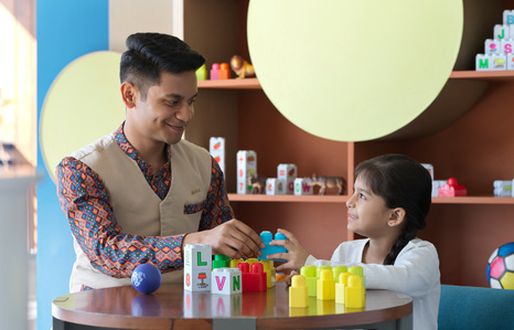commercial advertising photographer captures a young kid interacts with charming hotel staff for brand