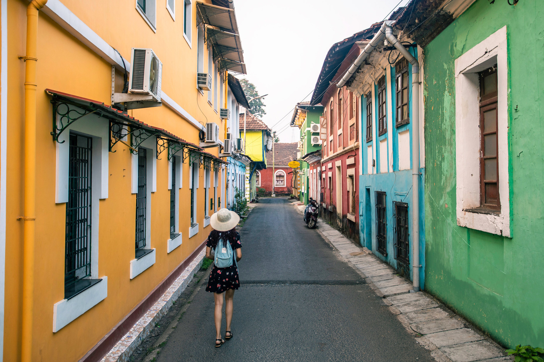 roaming around the colourful goan streets with a hat and touristy dress exploring the curious mind with the leading product photographer based in pune india