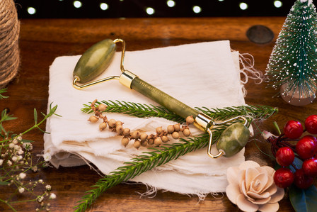 christmas theme photoshoot of a jade face roller sitting on a decorated pillow for a creative studio photoshoot for top still life photographer specialising in cosmetic and luxury brands ashish gurbani  based in pune india