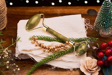 christmas theme photoshoot of a jade face roller sitting on a decorated pillow for a creative studio photoshoot for top still life photographer specialising in cosmetic and luxury brands ashish gurbani  based in pune india