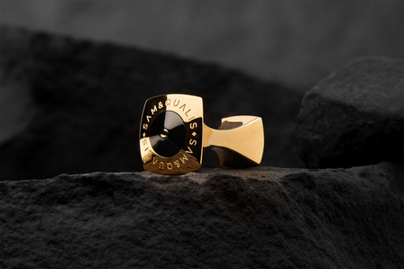 a golden glowing cufflink shot in bulb photography setup using photo studio equipments on rock mountain conceptual product photography of luxury products based in pune and mumbai india