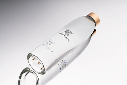 high end crystal water bottle placed on a mirror background photographed by Top creative product photographer in Mumbai