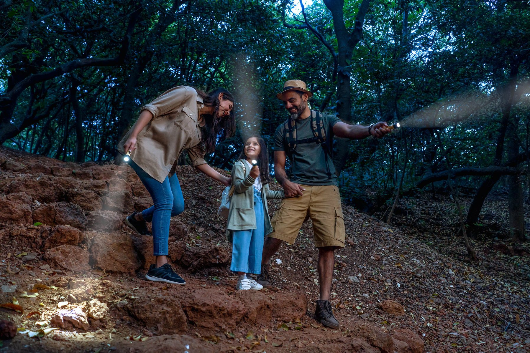 a family picnic in the jungle with torches for a hospitality brand in mahabaleshwar le meridien brand campaign photoshoot by indian photographer based in mumbai india