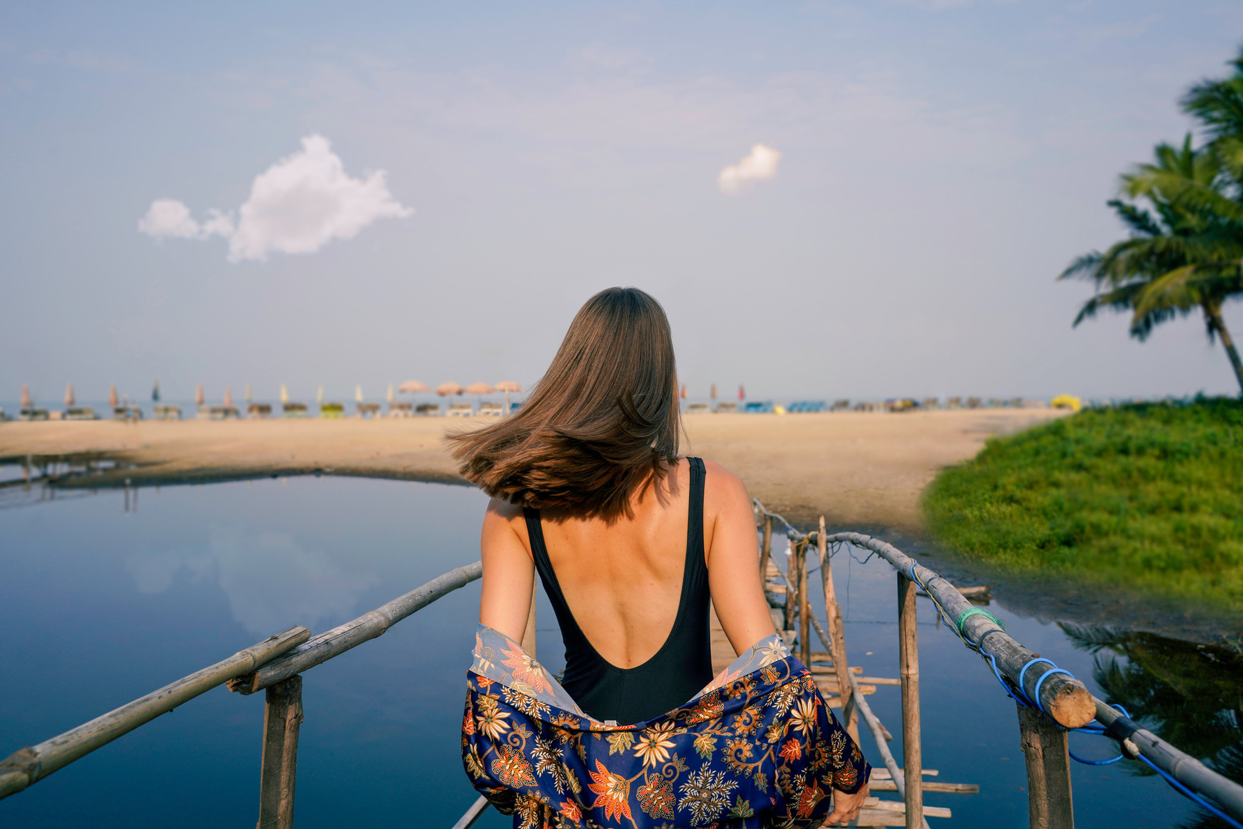 a beautiful girl walking down a bridge to a serene goan beach for marriott bonvoy campaign photoshoot by top advertisin photographer based in india