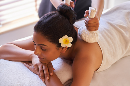 a lady enjoying a relaxing back massage captured by best ad photography studio in india