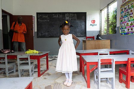 Portrait shot of a young girl smiling inside a classroom by ashish gurbani, top photographer in mumbai, India.