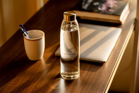 a work from home scenario created with a luxury brand water bottle shot by Top Lifestyle photographer in pune
