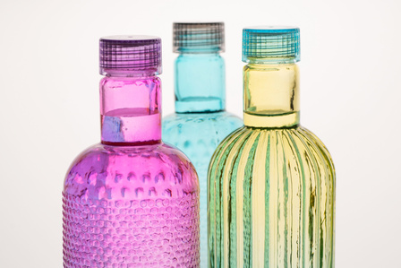 photograph of the top half of three transparent bottles professionally shot in a studio setup with a white background by leading product photographer ashish gurbani based in pune india