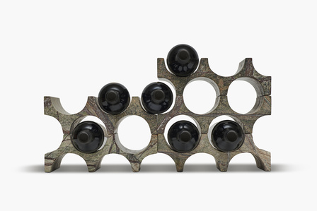 multiple wine bottles placed on a beautifully cut wine bottle holder stand by luxury product brand gessato