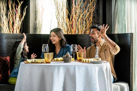 family having a jolly time between father and daughter bonding on the dining table in a restaurant for lifestyle hotel creative photoshoot by best lifestyle photographer based in Mumbai india 