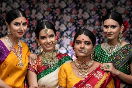 Group of Indian models posing with patola sarees for jewellery advertising campaign photoshoot by leading Indian fashion photographer based in Mumbai India.