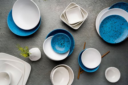 white and blue textured luxury plates on a table setup by top product photographer for advertising campaign shoot ashish gurbani based in mumbai india