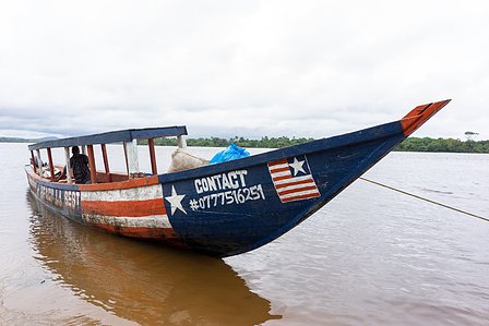 Fish boat sailing inside a lake in Monrovia shot by Ashish Gurbani top photographer based in Mumbai India.