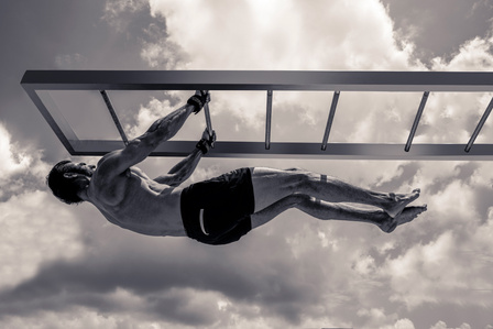 feeling suspended concept based fitness photoshoot on model suspended off a ladder concept photography with leading fashion and advertising photographer based in mumbai india