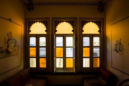 Beautiful, translucent and subtly colored symmetric windows inside a room also having drawings on the wall shot by Ashish Gurbani top fashion photographer based in Mumbai India.  