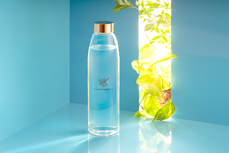a conceptual blue background with a hint of green nature for branding exercise of a water bottle brand based in germany by top still life photographer based in mumbai india